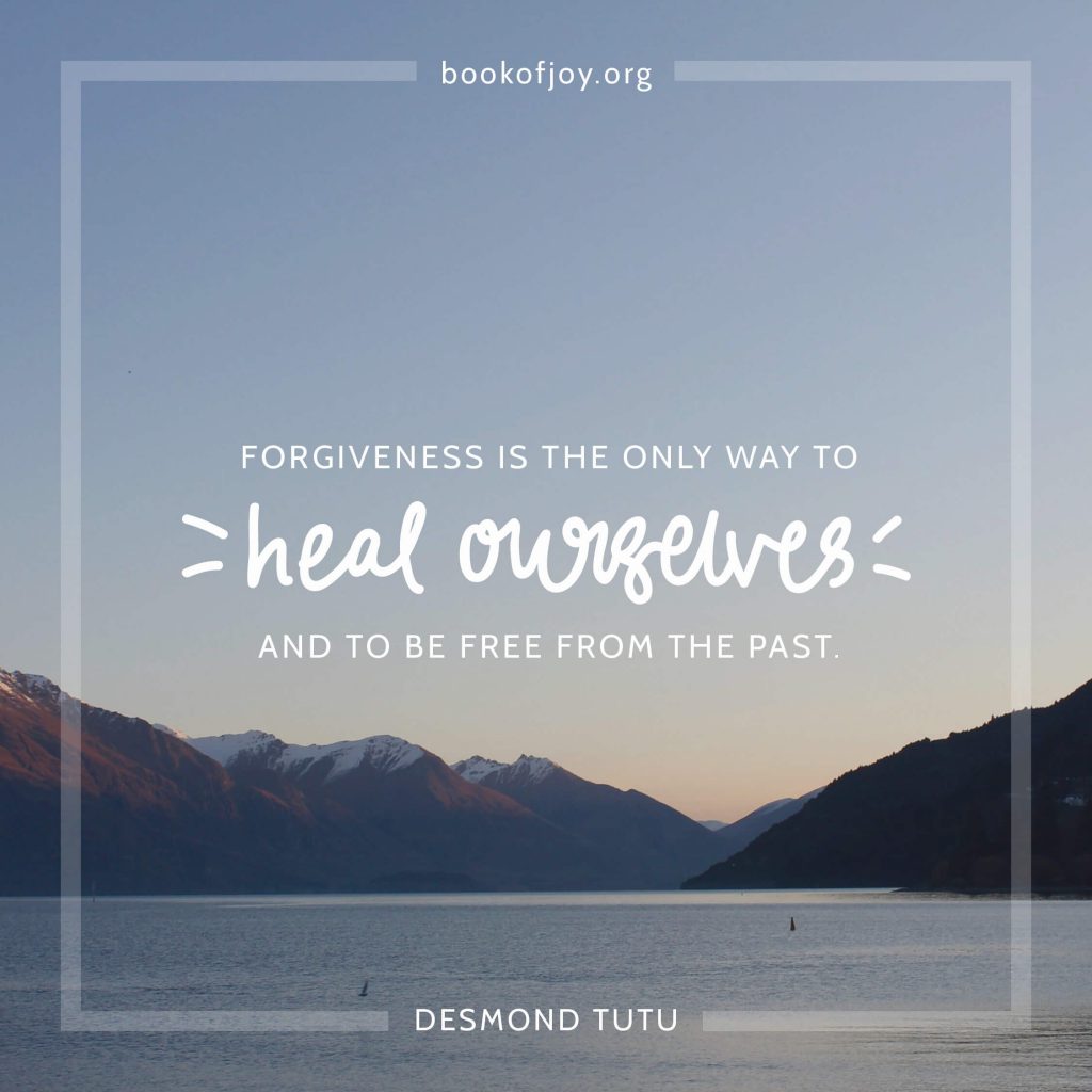 A photo of water and mountains with lots of blue sky showing a DT quote that forgiveness is the only way to heal ourselves and to be free from the past