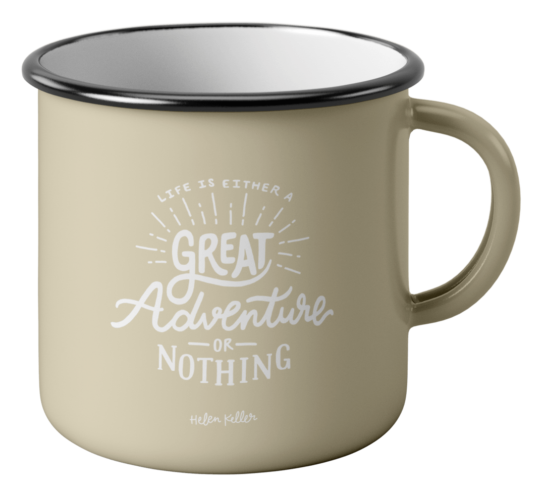 A cream colored metal mug with handlettering reading Life is either a great adventure or nothing at all - a quote by Helen Keller