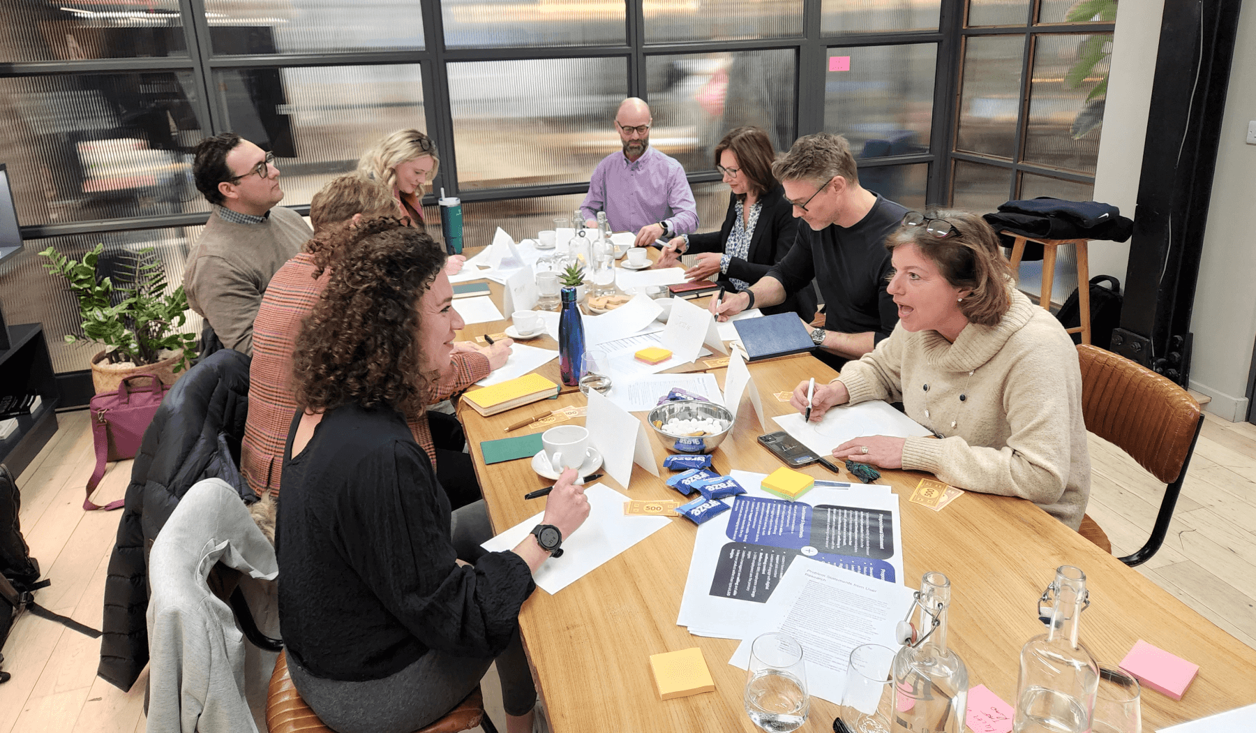 Photo of some of the workshop participants working around the table.