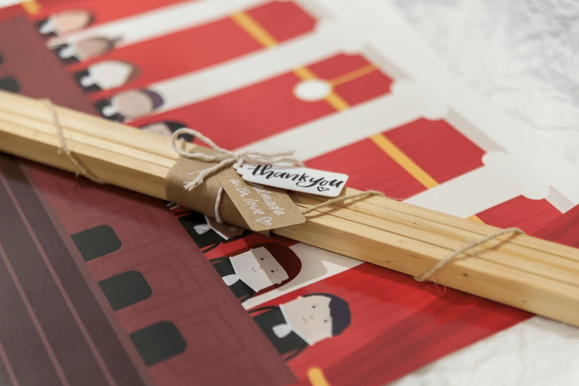 A photo (shot be me) of a close up of a finished frames product where in the centre I wrapped each frame order with leftover brown paper scraps and a little tag with a handlettered thank you note